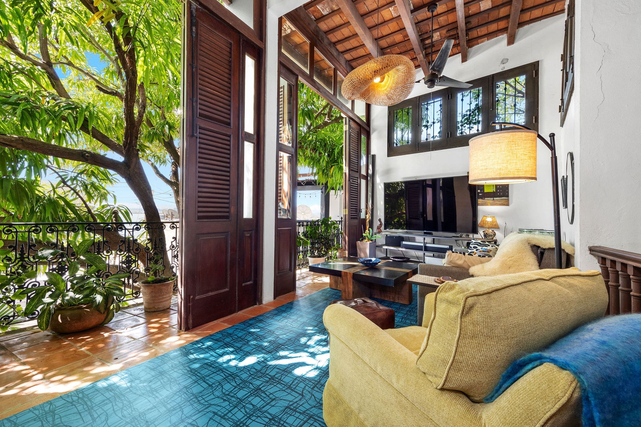 Open living room with balcony doors in Old San Juan apartment